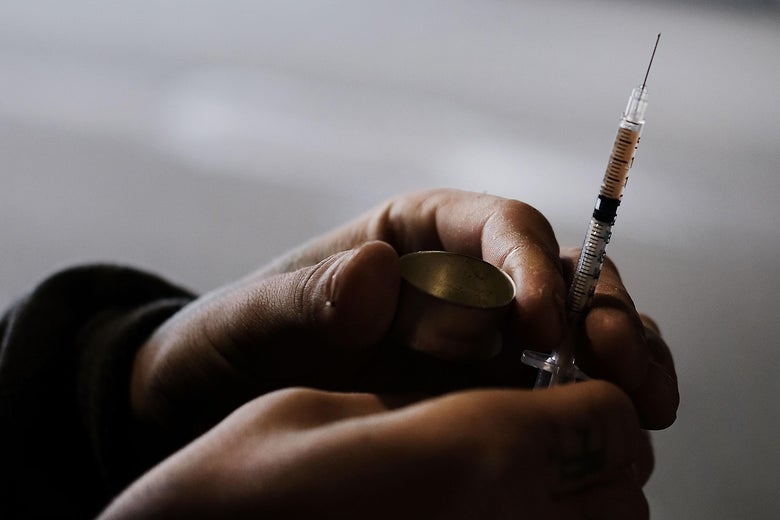 A man uses heroin under a bridge where he lives with other addicts in Kensington, Philadelphia.